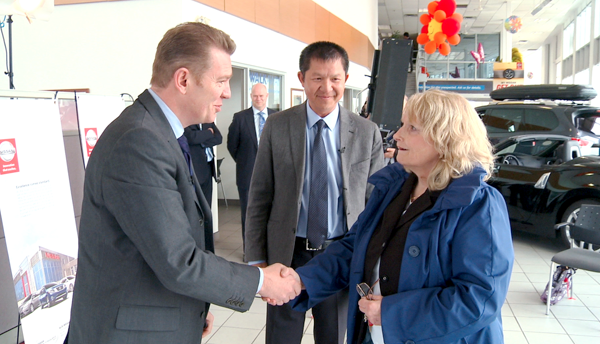 Karen Ackroyd (far right) receives the keys to her new 2015 Micra from Christian Meunier, President, Nissan Canada Inc. (left). In the centre is Edward Wong, Principal Owner, Alta Nissan