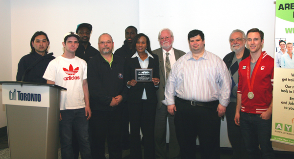 (Left to right) Carlos Juco, Class of 2010, Lorne Jackson, Class of 2012, Mohammed Baruwa, Class of 2013, Wayne James, Maaco Systems Canada, Usman Baruwa, Class of 2013, Nimo Abdulkadir, Director of AYCE Employment Services, John Norris, Collision Industry Information Assistance, Marc Tremblay, coordinator AYCE Pre-apprenticeship Training Program, Achim Krull and Jason Burnett, Olympic Silver Medalist.