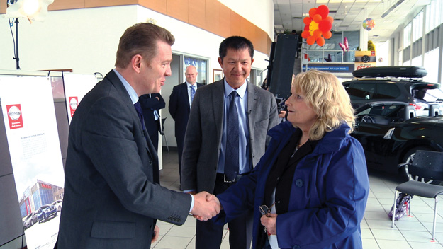 Karen Ackroyd receives the keys to her new 2015  Micra from Christian Meunier, President, Nissan Canada Inc. (left). In the centre is Edward Wong, Principal Owner, Alta Nissan 